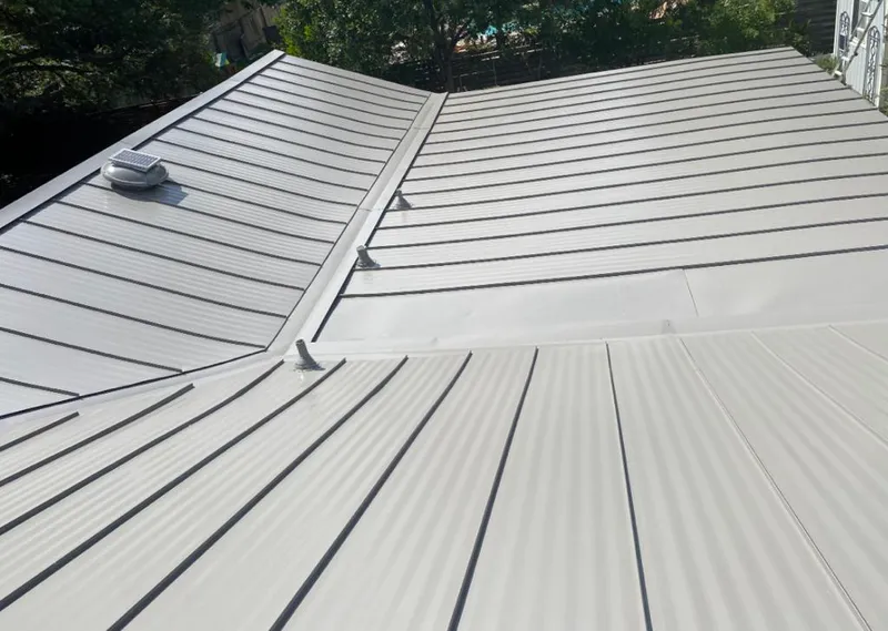 Solar attic fan installed on a metal roof for Roof Ventilation in Lake of the Woods